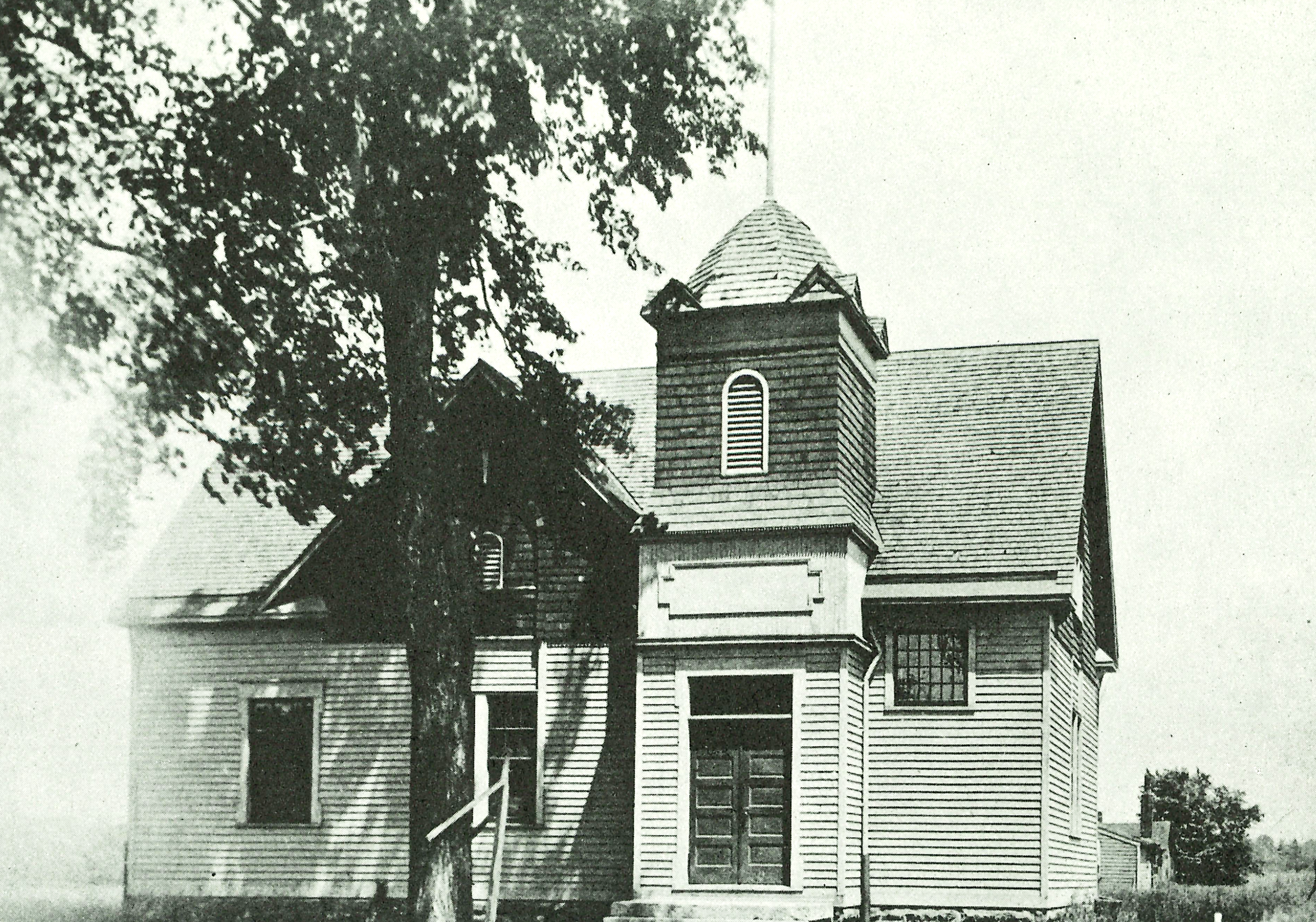 Exterior black and white photograph of the former City of South Euclid town hall. The building sits behind a large tree.